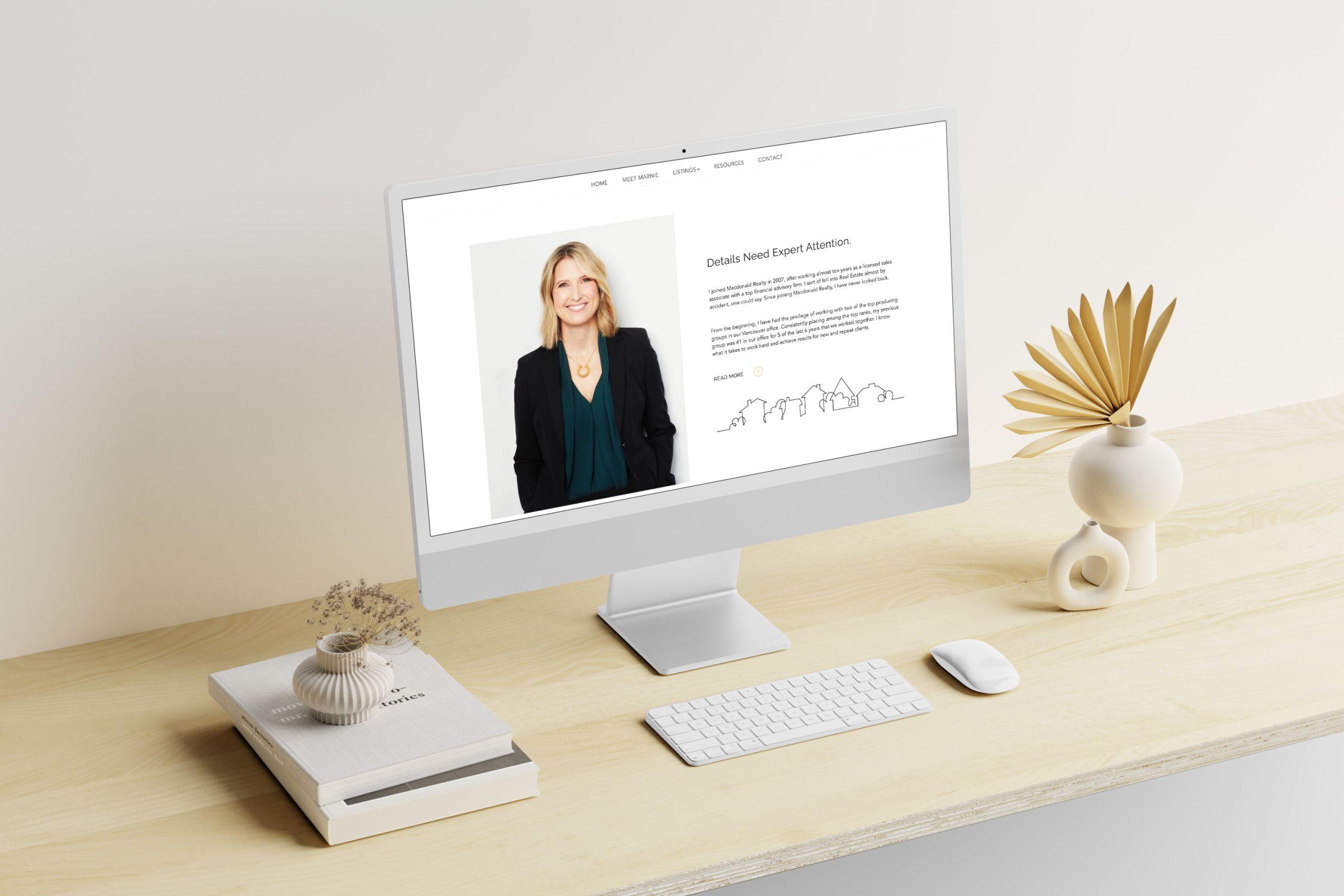Desktop mockup of Marnie Quarry's website on a desk in natural light setting.